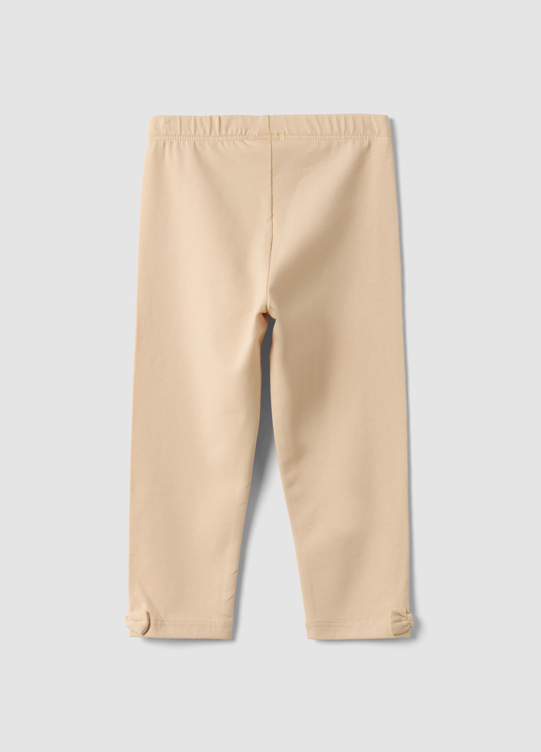 Beige stretch organic cotton leggings with bows for baby girl