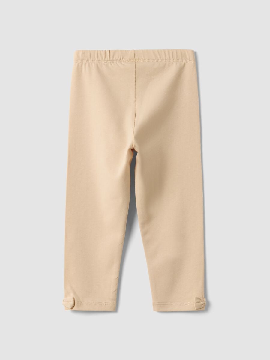 Beige stretch organic cotton leggings with bows for baby girl_1
