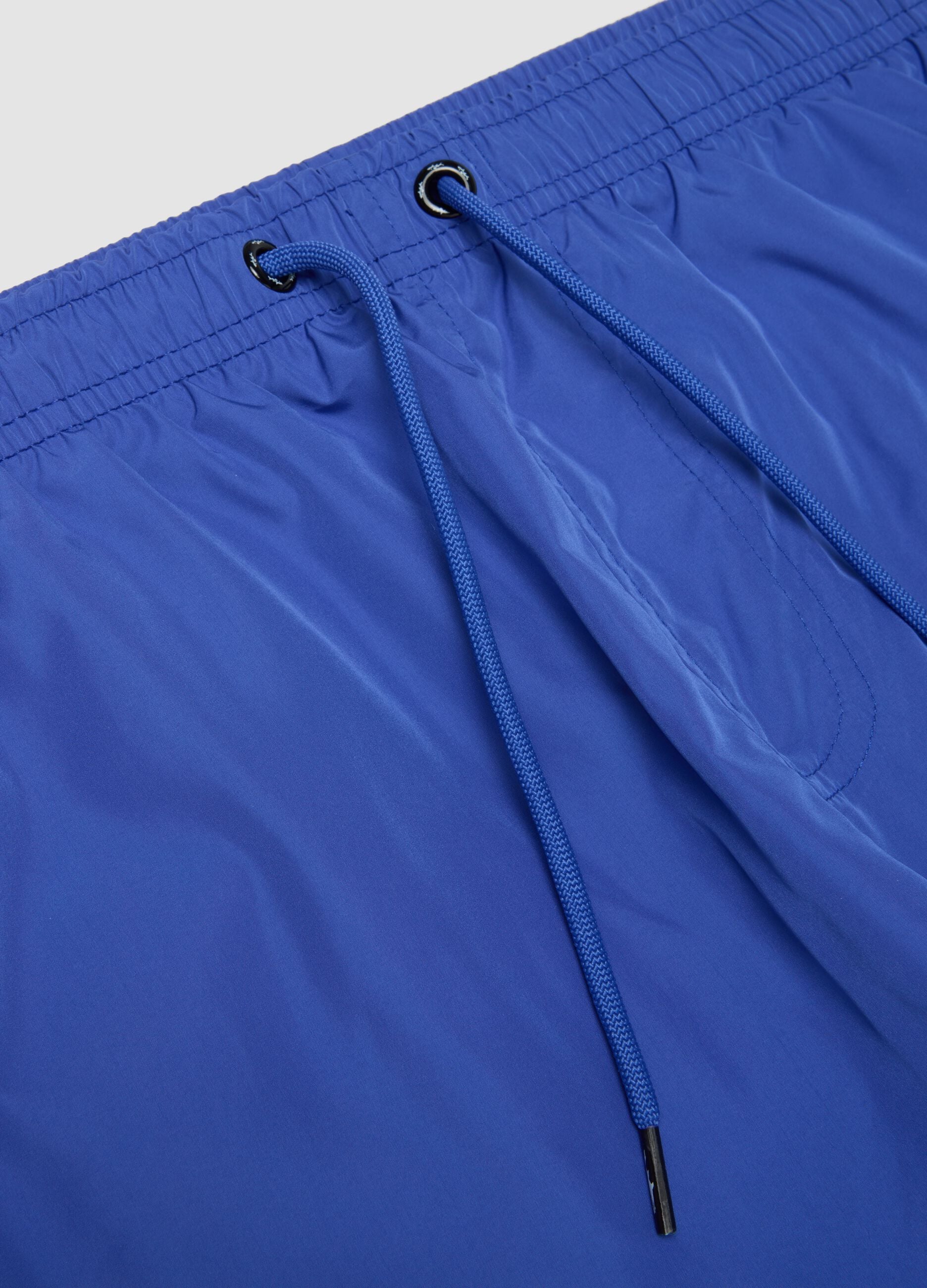Blue swim shorts with elasticated waistband and drawstring