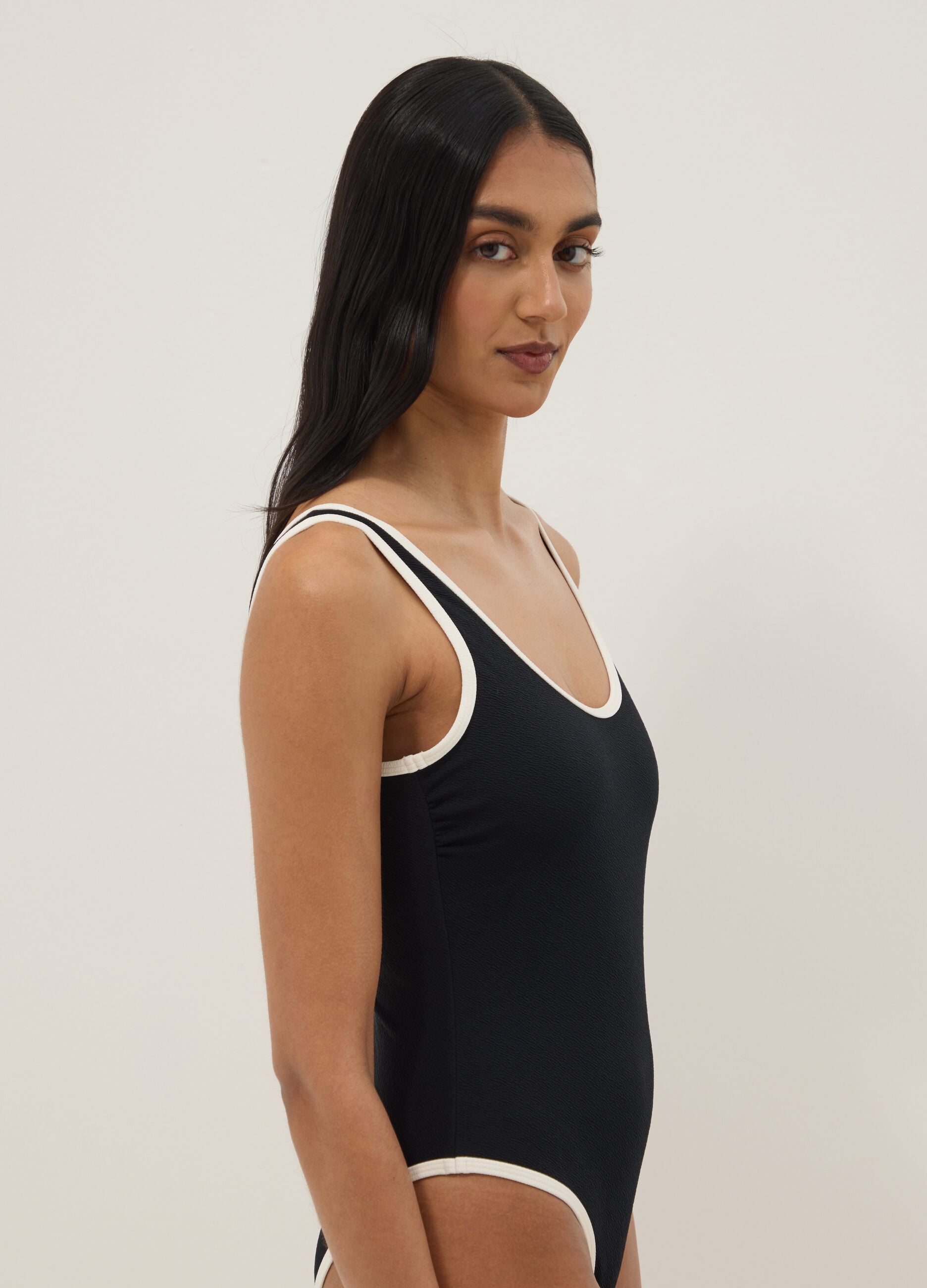 Black stretch one-piece swimsuit with white trim