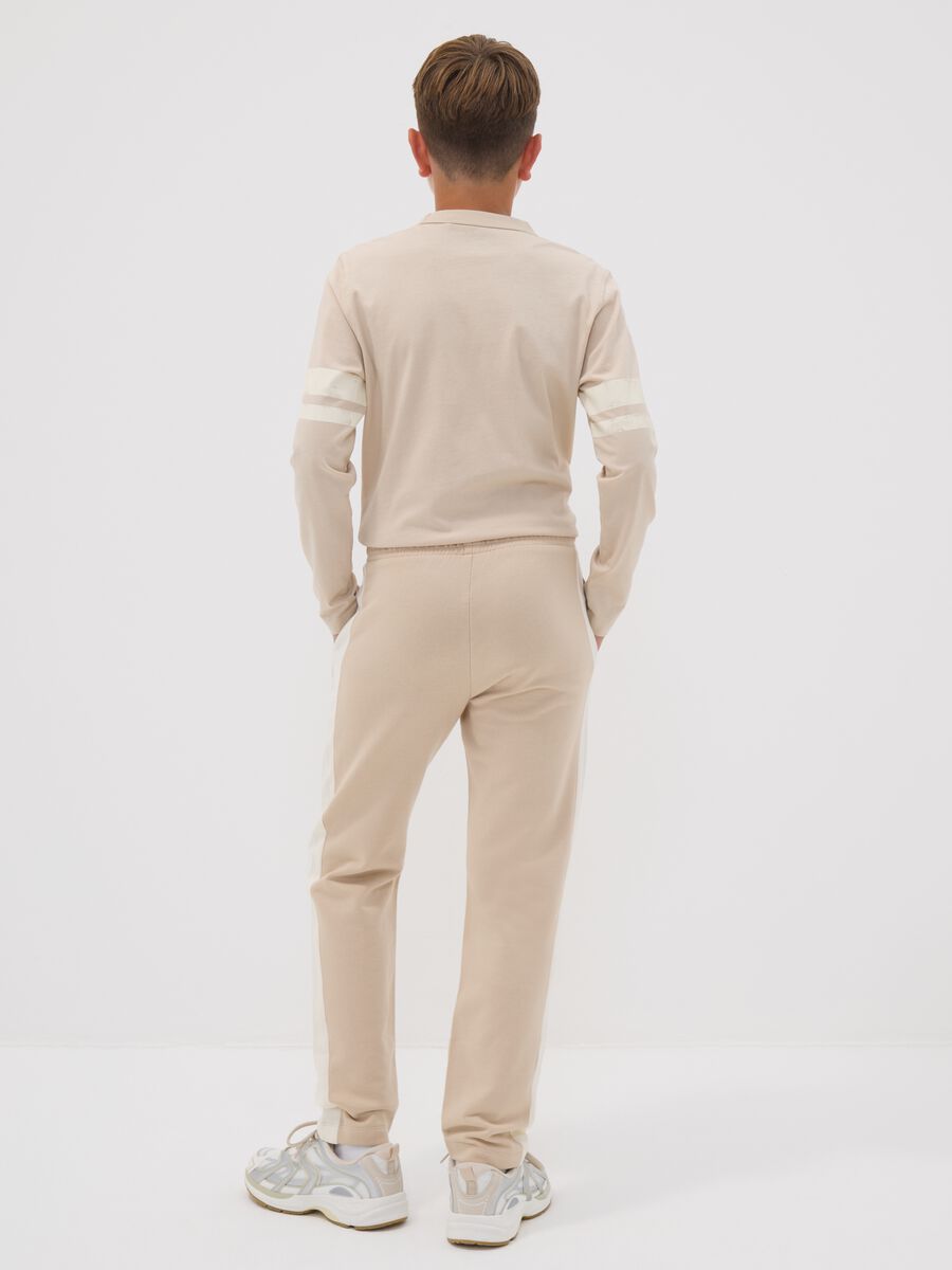Beige pure cotton jogger trousers with side stripes for boys_1