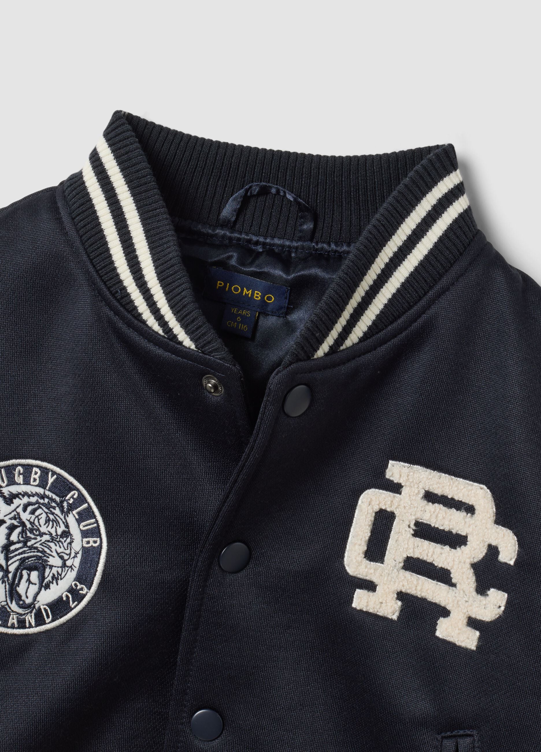 Blue varsity jacket with beige sleeves and print for boys