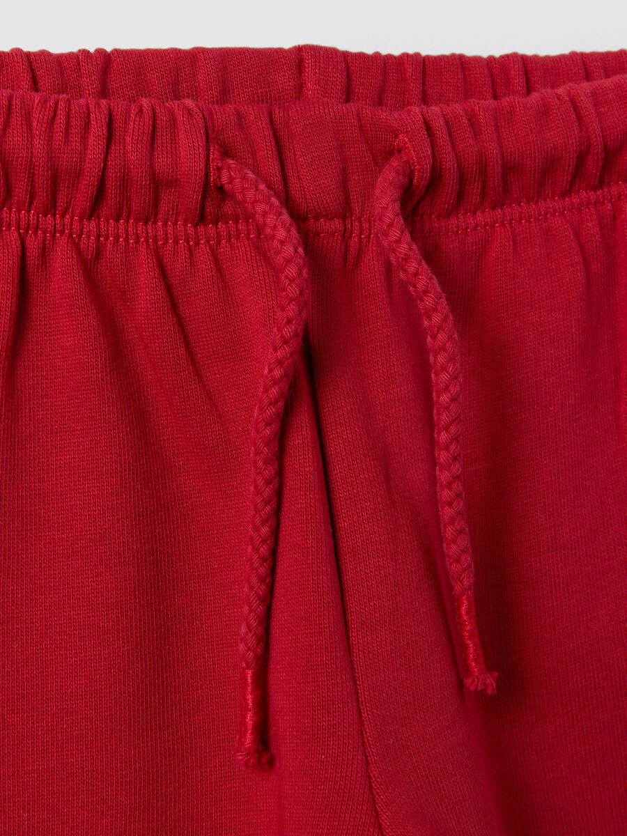 Red pure cotton trousers with elasticated waist and print for baby girls_3