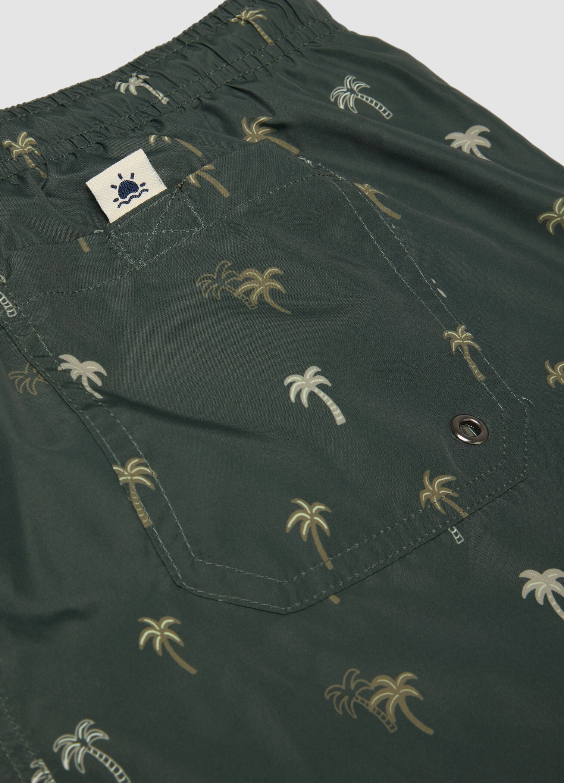 Green boxer swim shorts with palm print