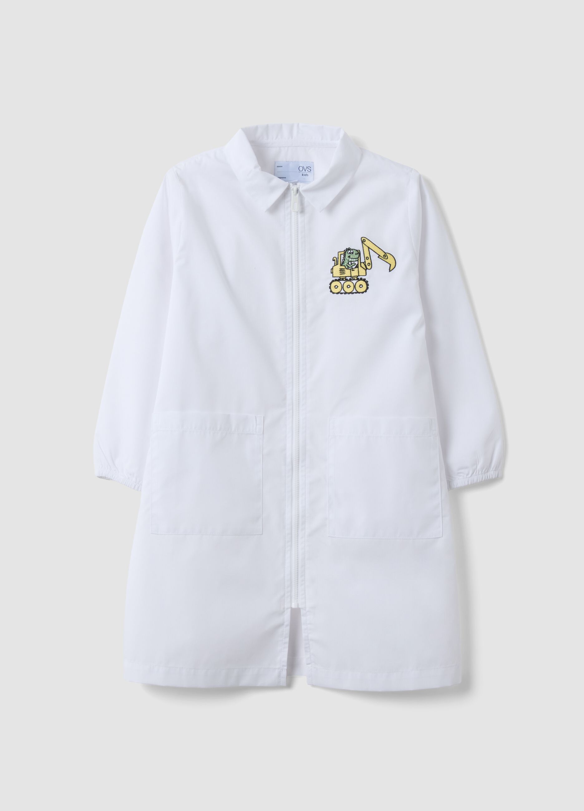 White nursery apron with zip and dinosaur embroidery for boys