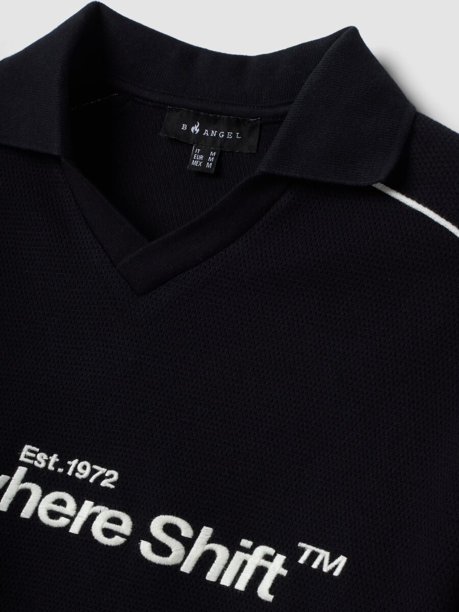 Polo nera in puro cotone over fit a maniche corte over fit_1