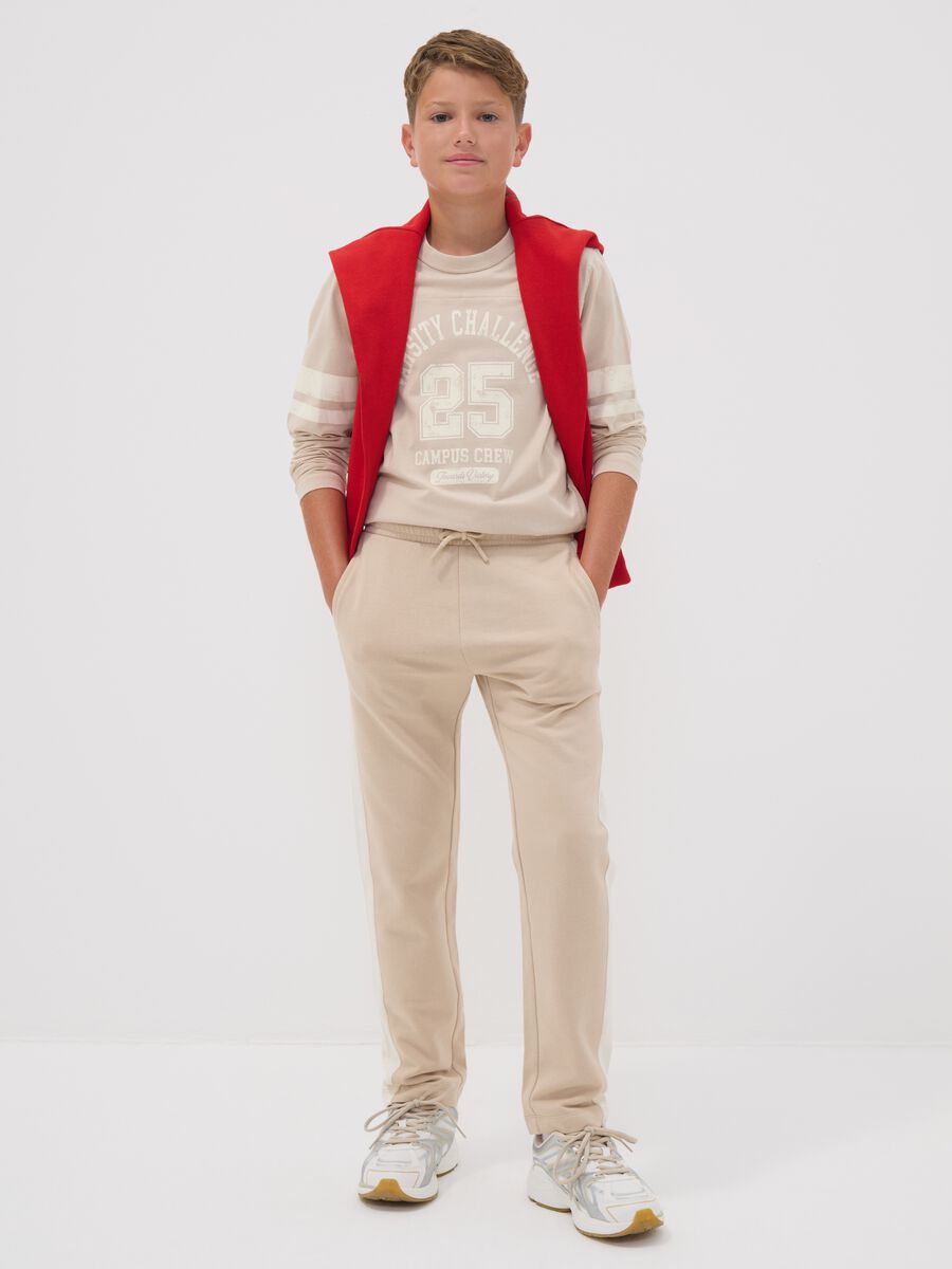 Beige pure cotton jogger trousers with side stripes for boys_0