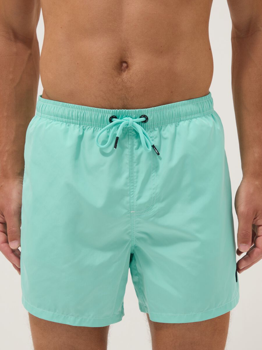 Light blue swim shorts with drawstring waist_1