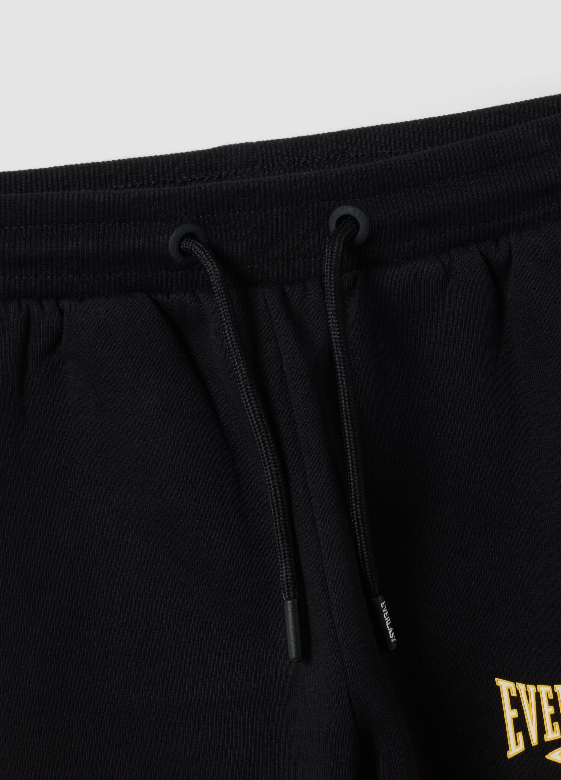 Black 100% cotton kids&rsquo; tracksuit bottoms with yellow side stripes