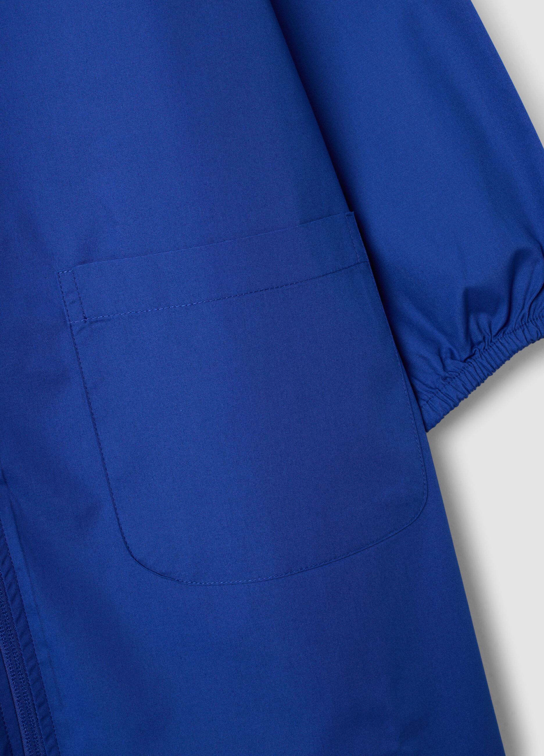 Blue girls&rsquo; school apron with rhinestone details and floral embroidery
