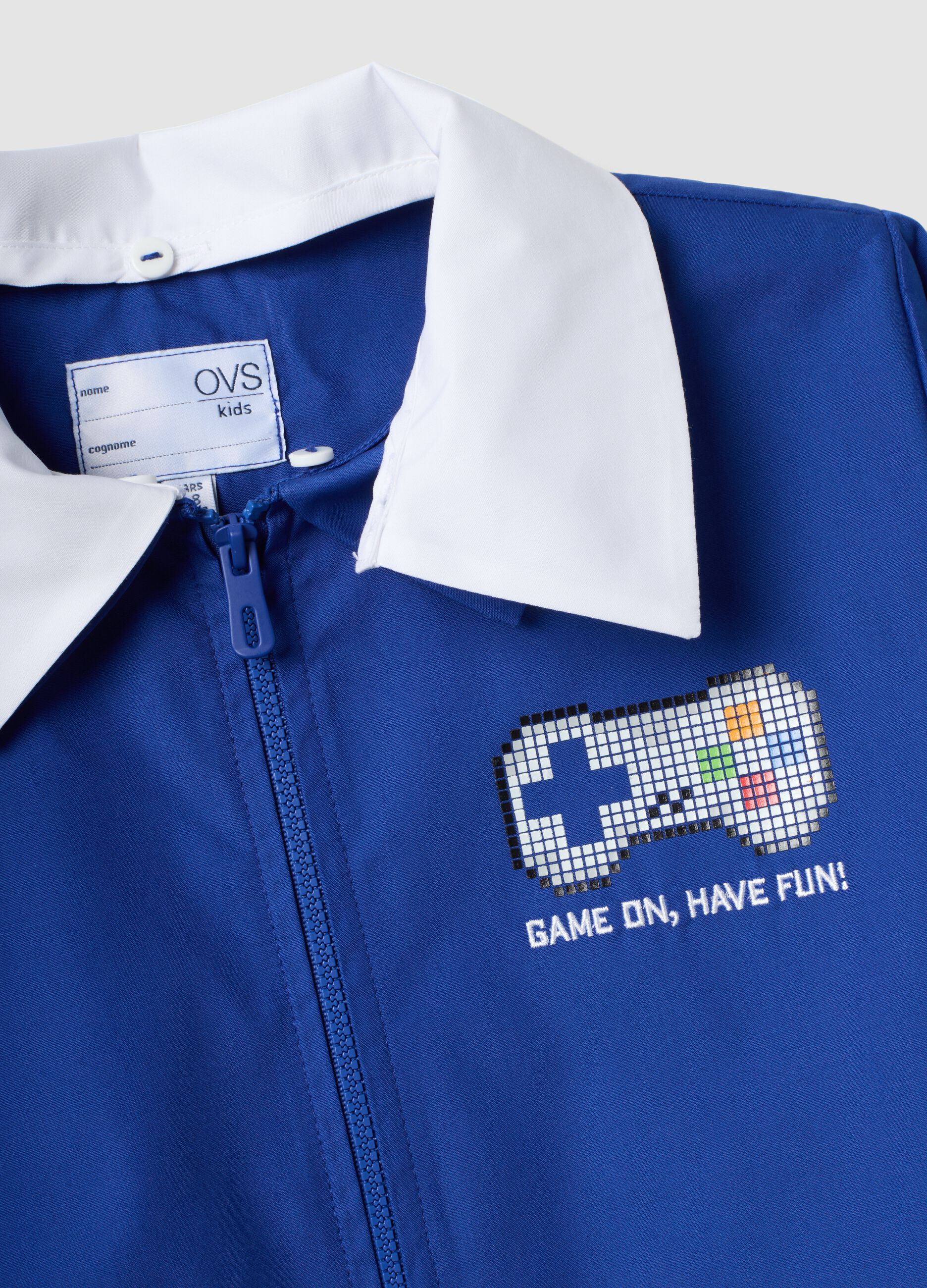Blue kids&rsquo; school smock with gaming print and white collar