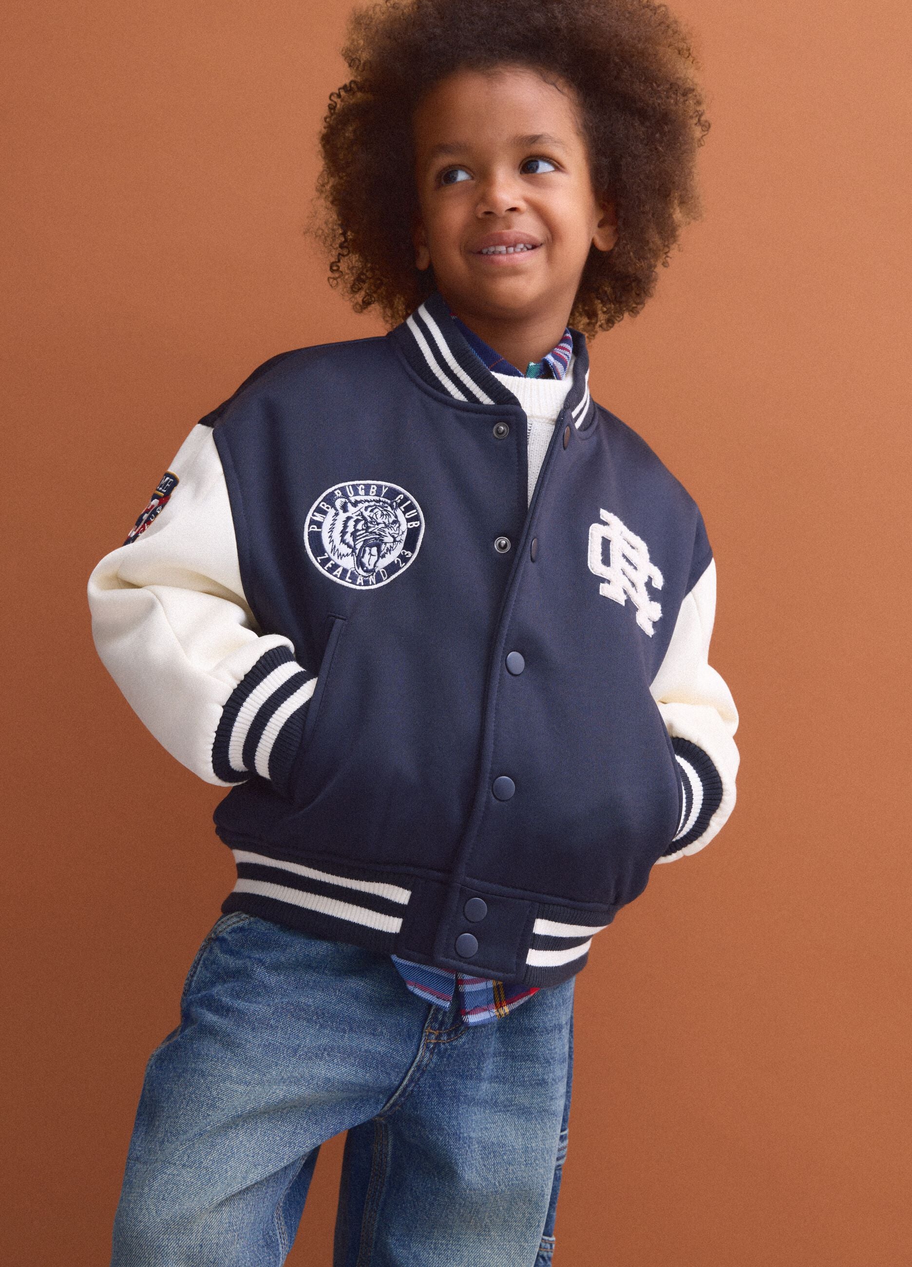 Blue varsity jacket with beige sleeves and print for boys