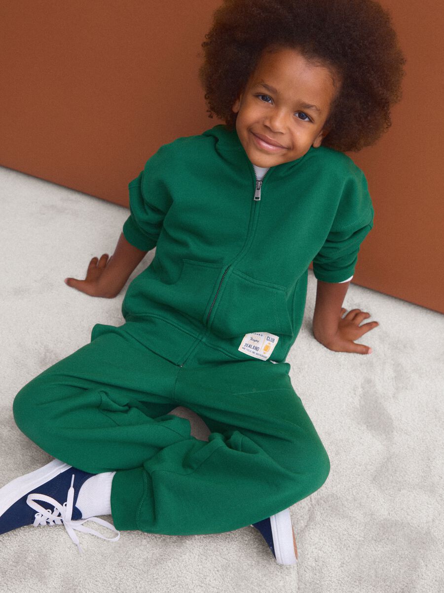 Green pure cotton jogger trousers with elasticated waist for boys_0