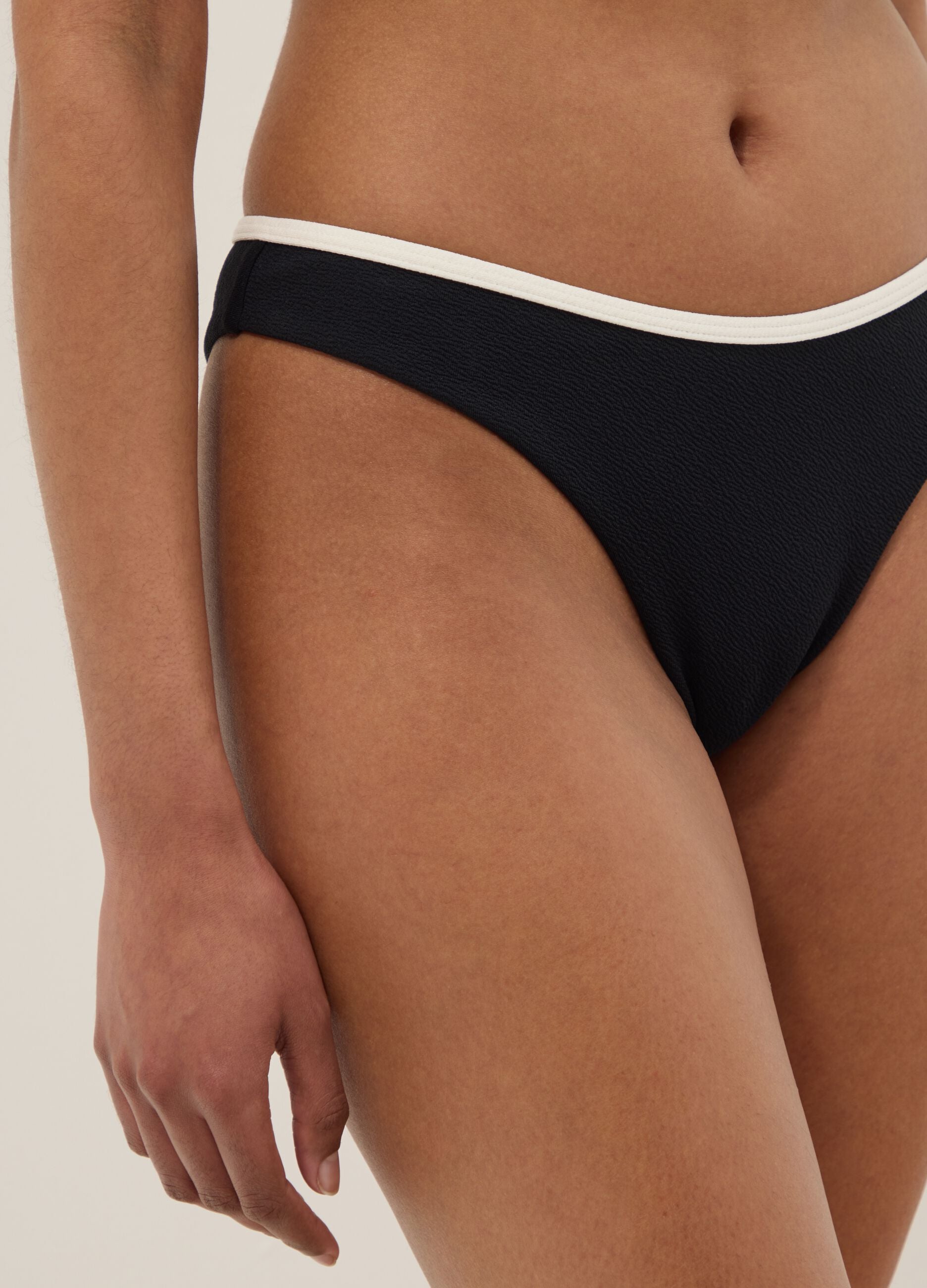 Black stretch swim briefs with white trim