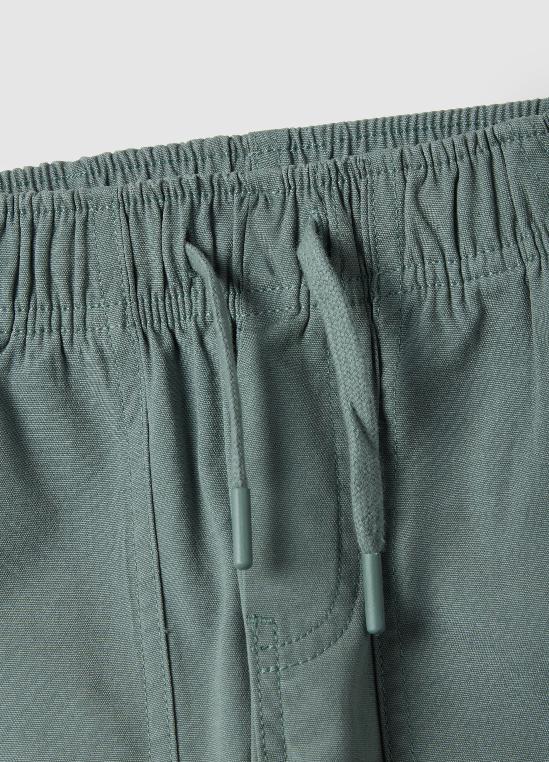 Green straight-legged cotton jogger trousers for kids