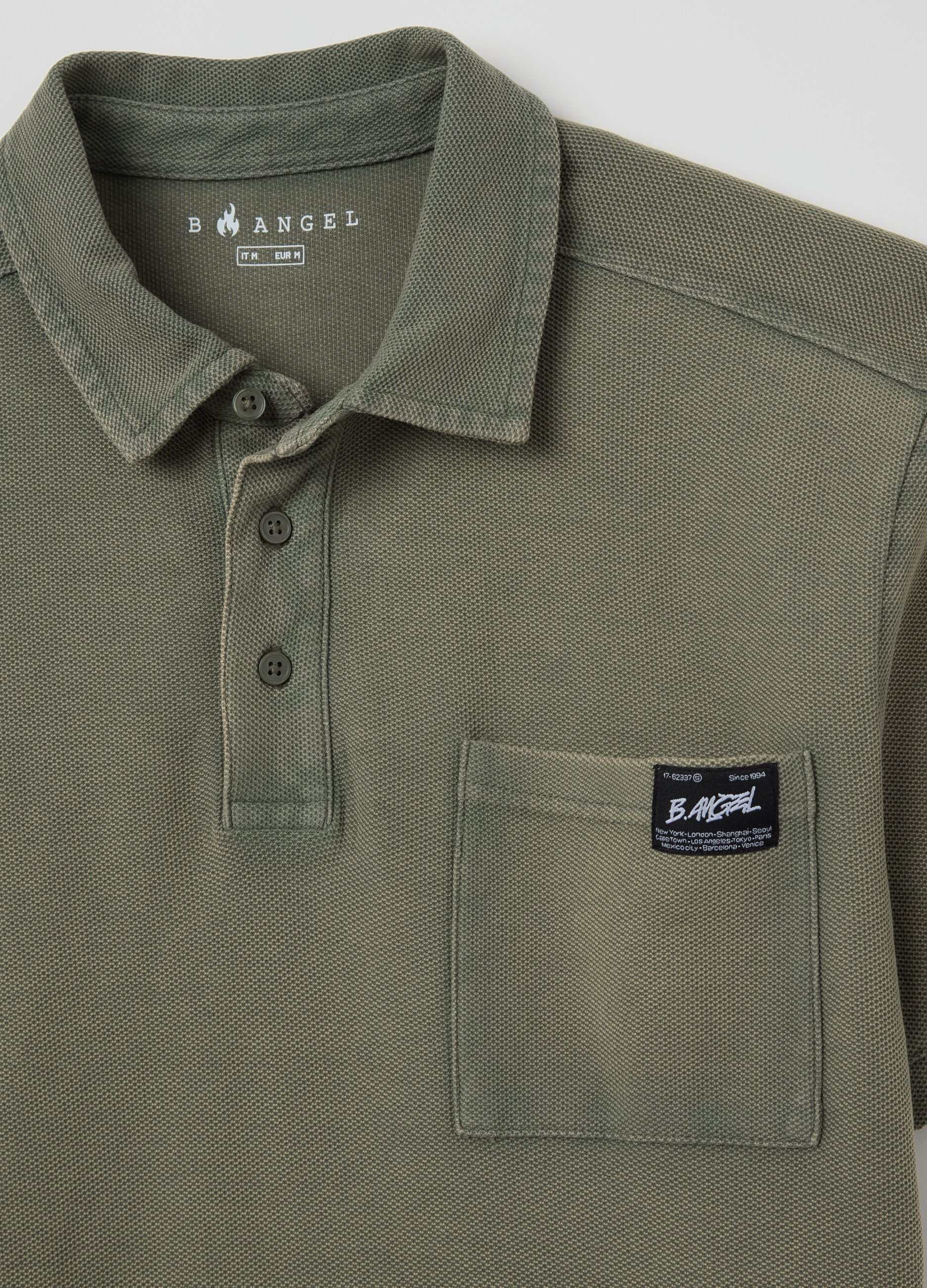 Green short-sleeved polo shirt in cotton piquet