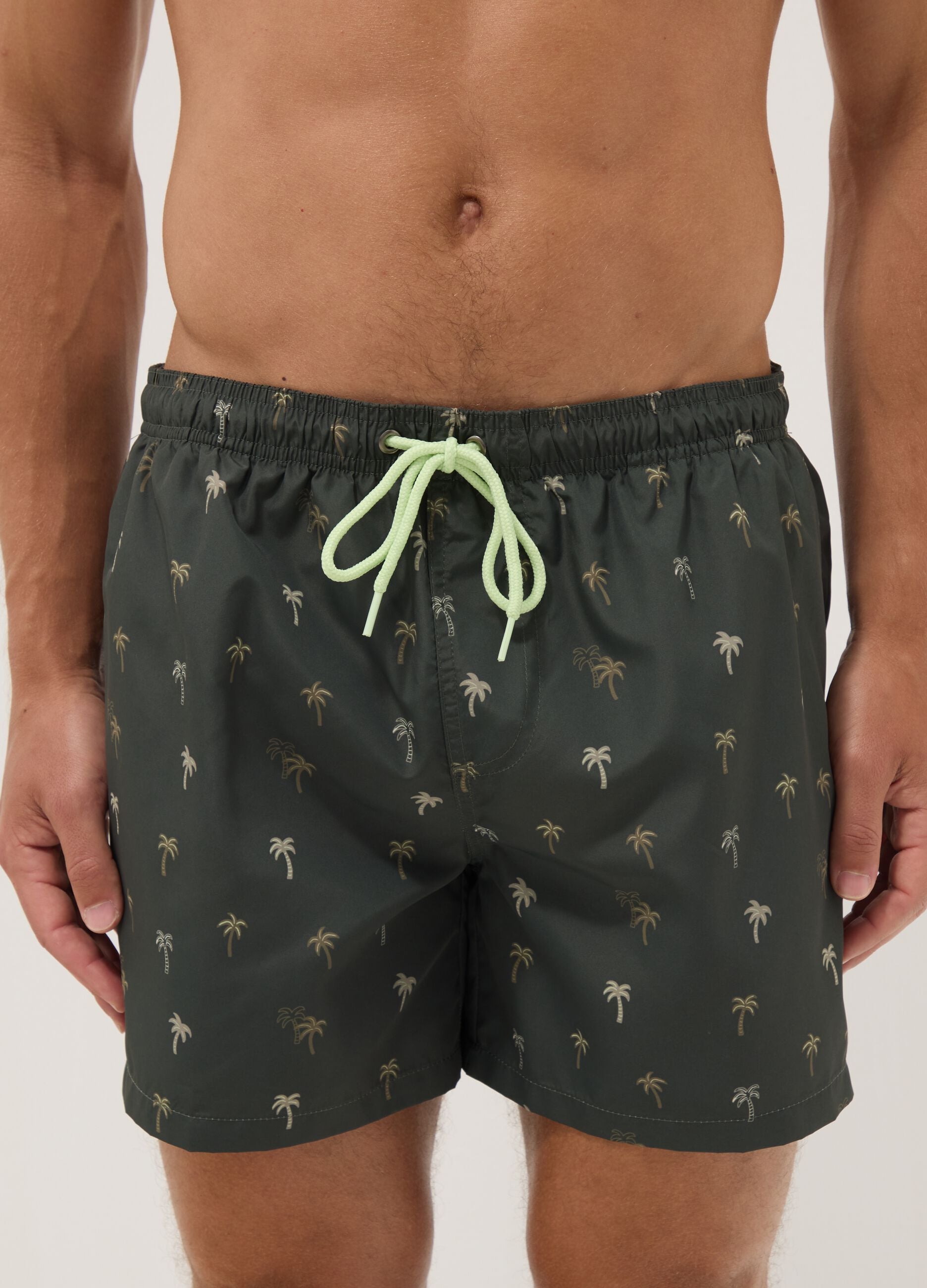 Green boxer swim shorts with palm print