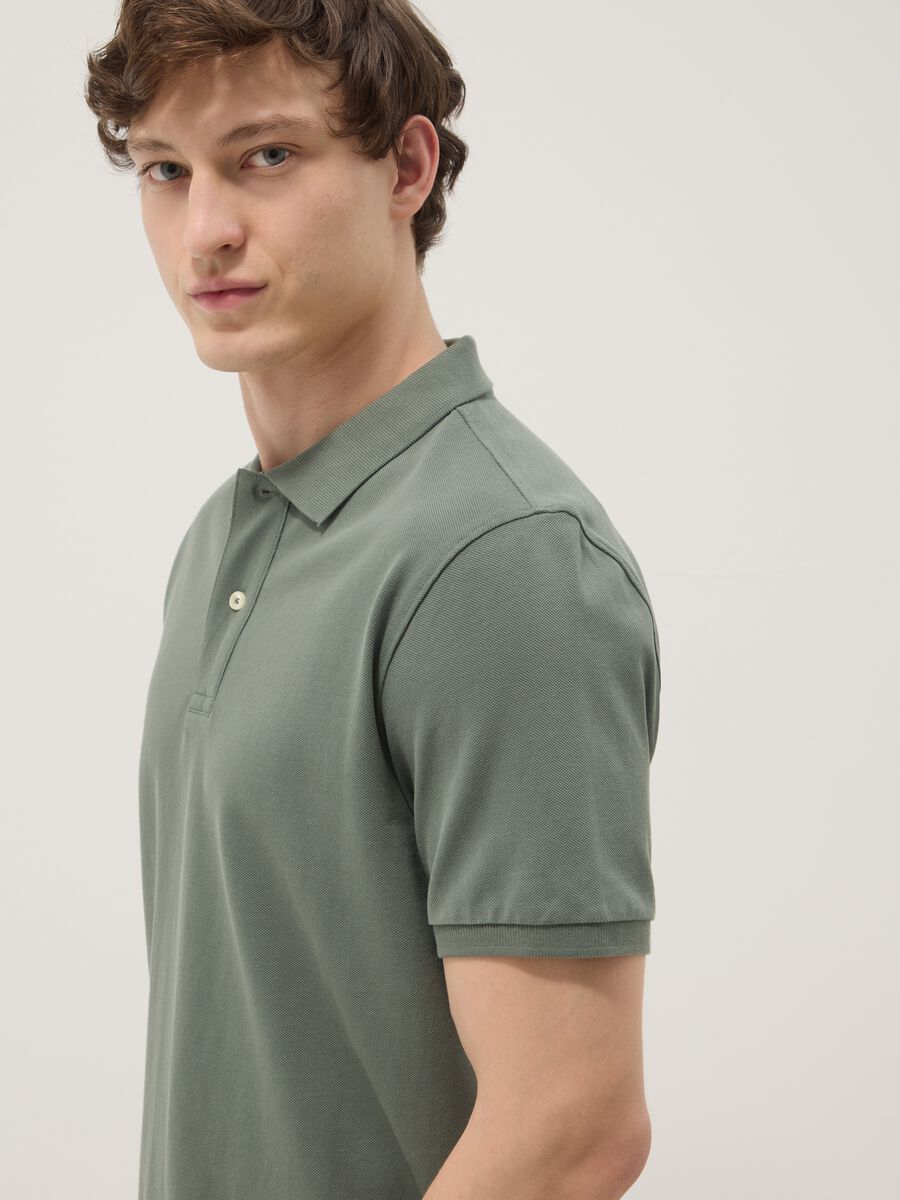 Green short-sleeved polo shirt in pure organic cotton_1