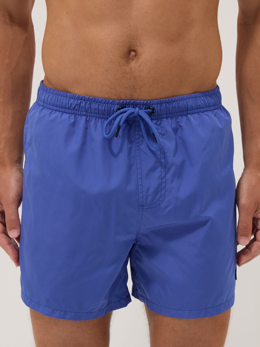 Blue swim shorts with elasticated waistband and drawstring_1