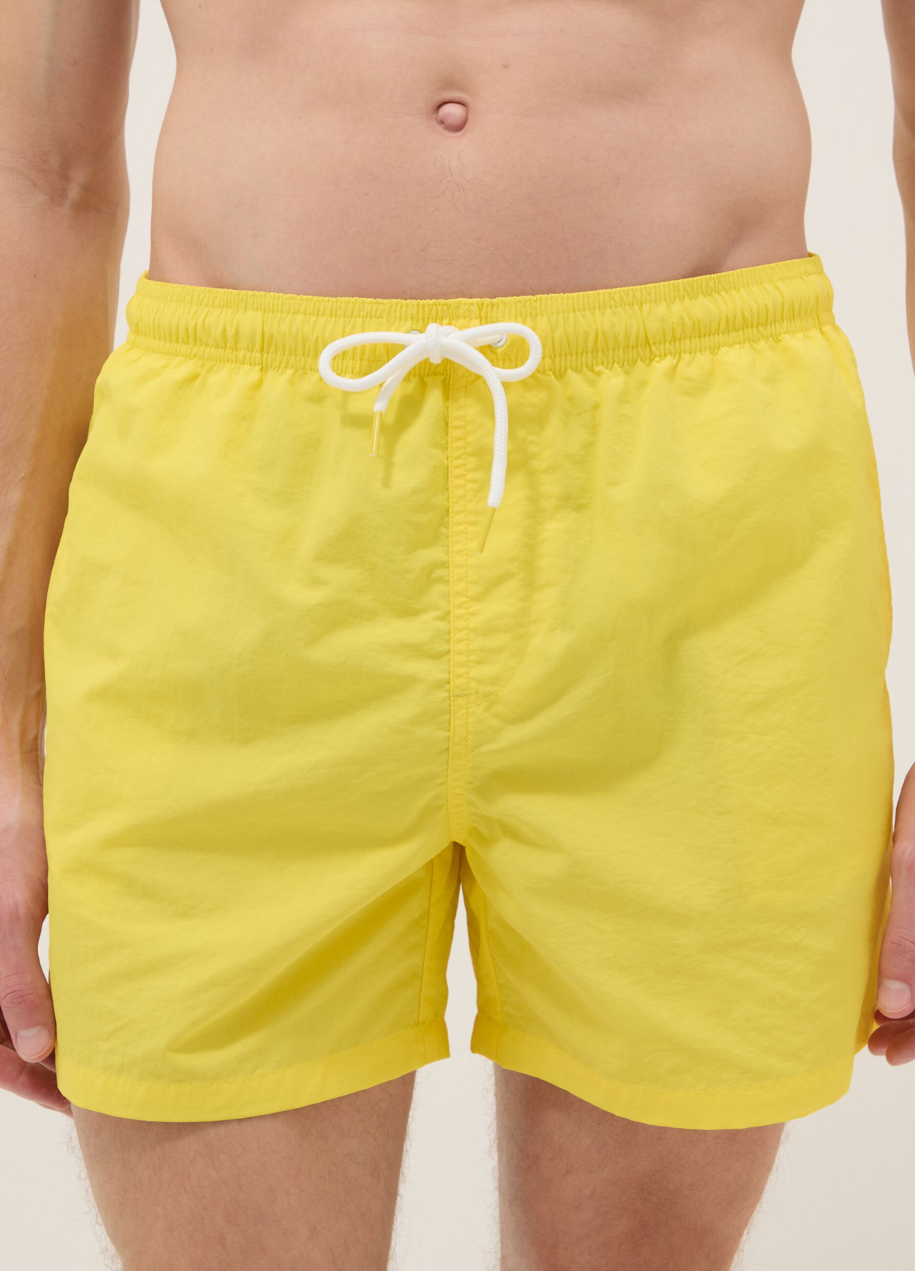 Yellow swim shorts with elasticated waistband