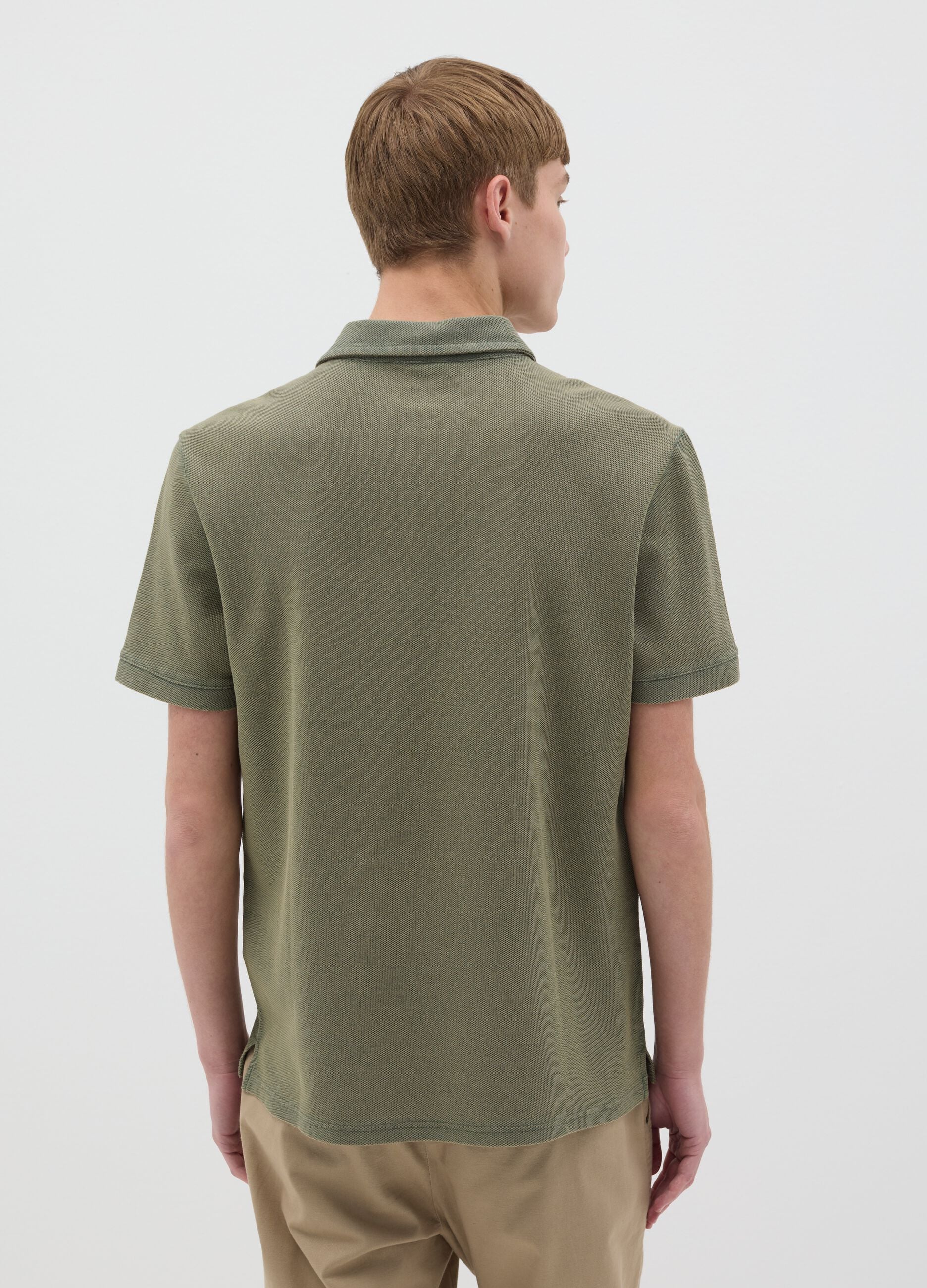 Green short-sleeved polo shirt in cotton piquet