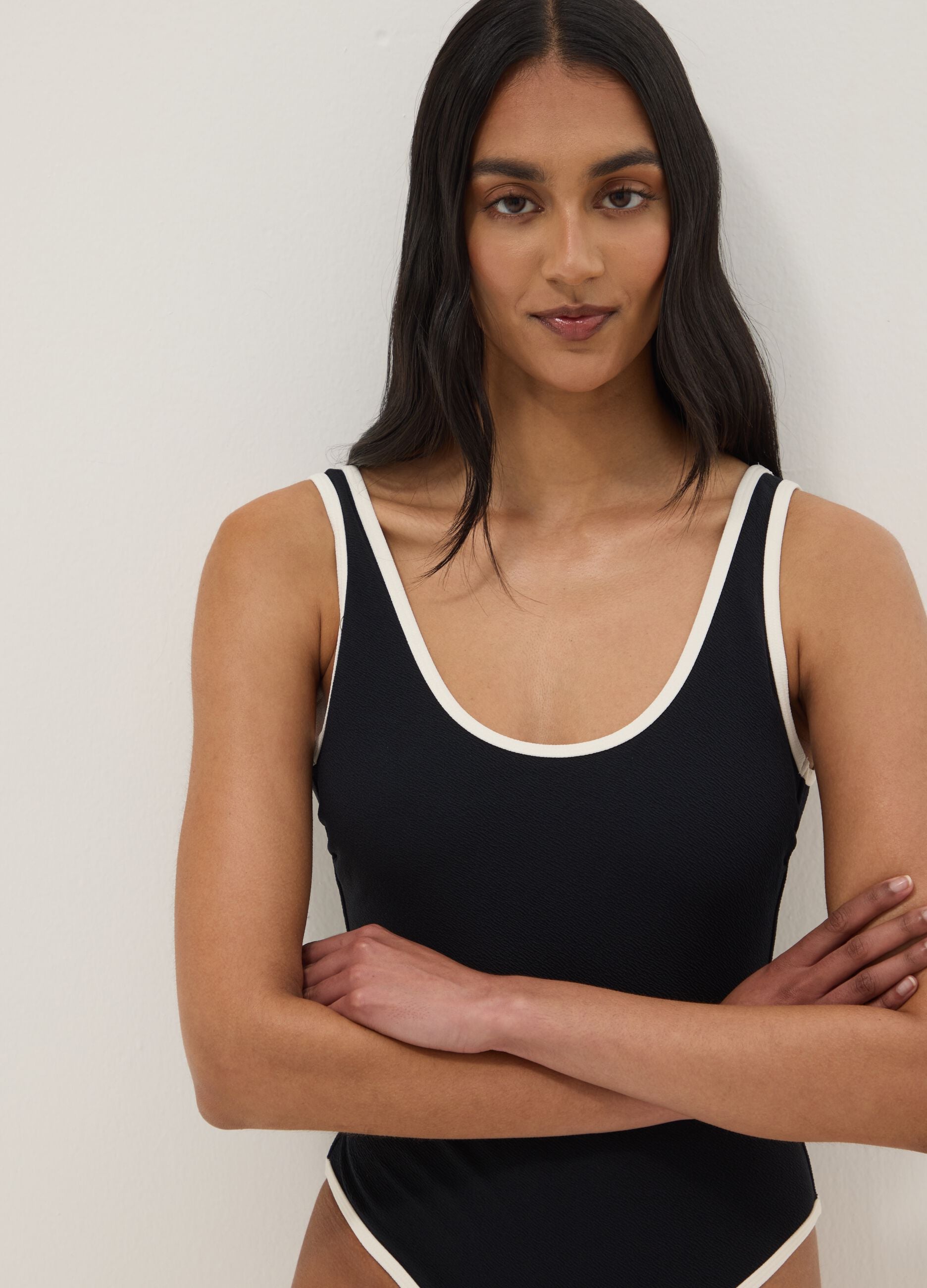 Black stretch one-piece swimsuit with white trim