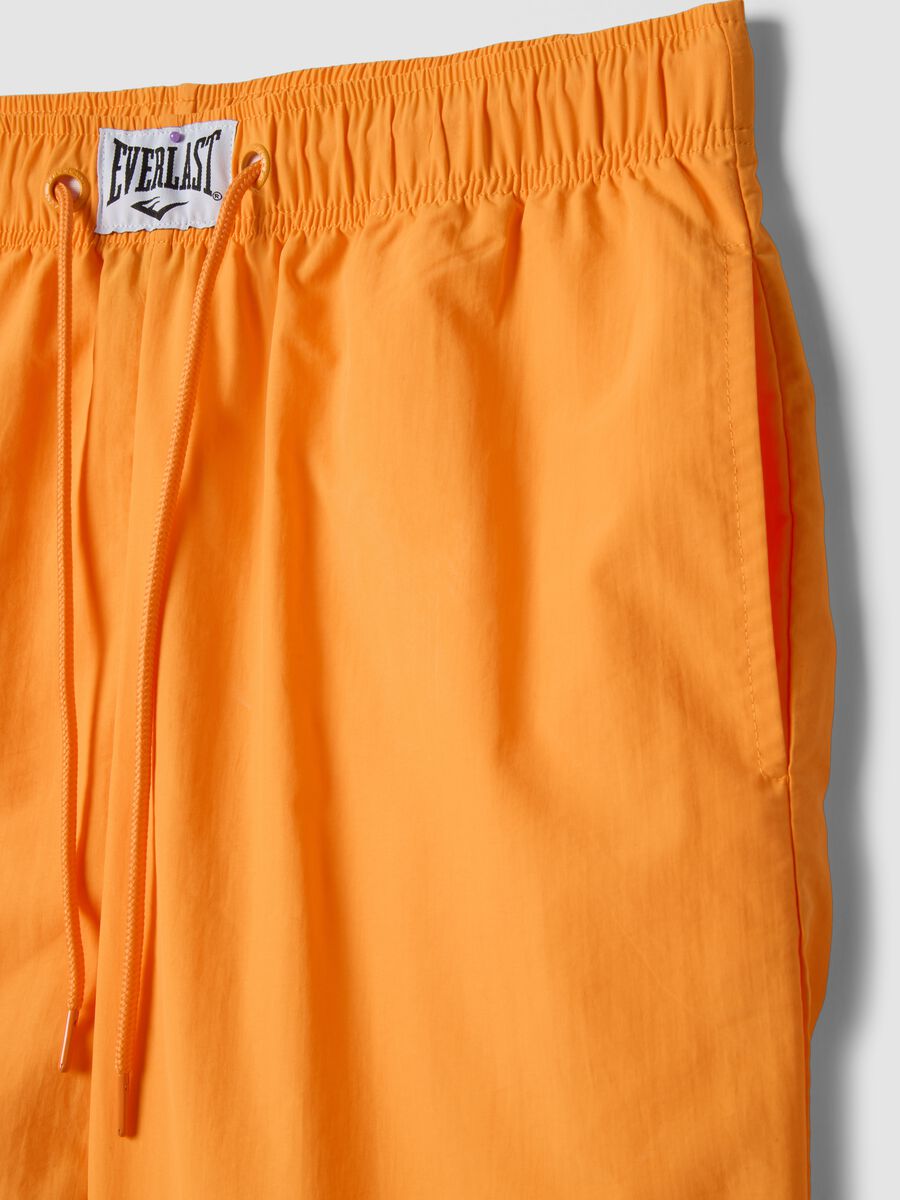 Orange regular fit sports shorts with white and black details_5