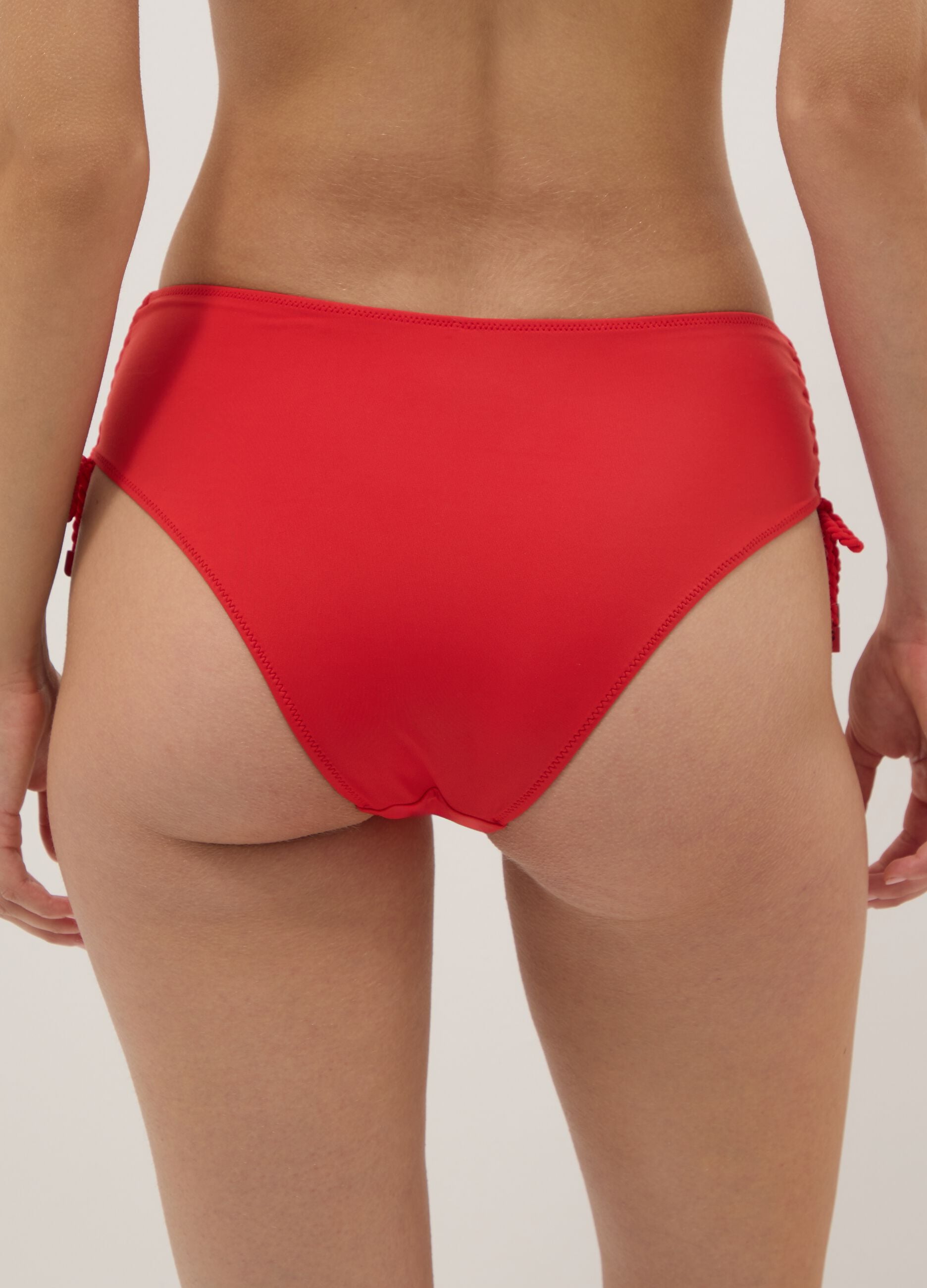 Red bikini bottoms in stretch fabric with side ties