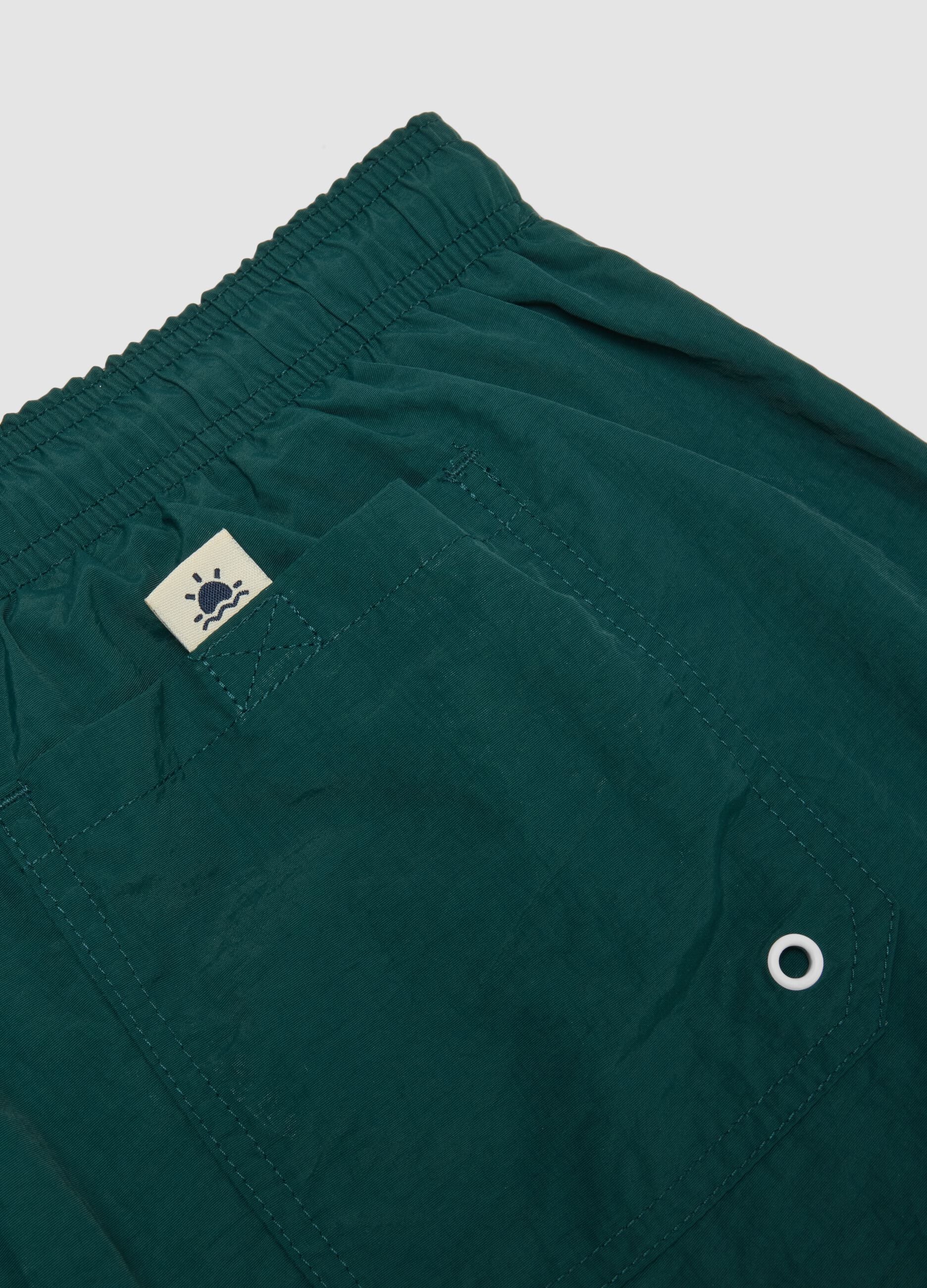Green swim shorts with elasticated waistband