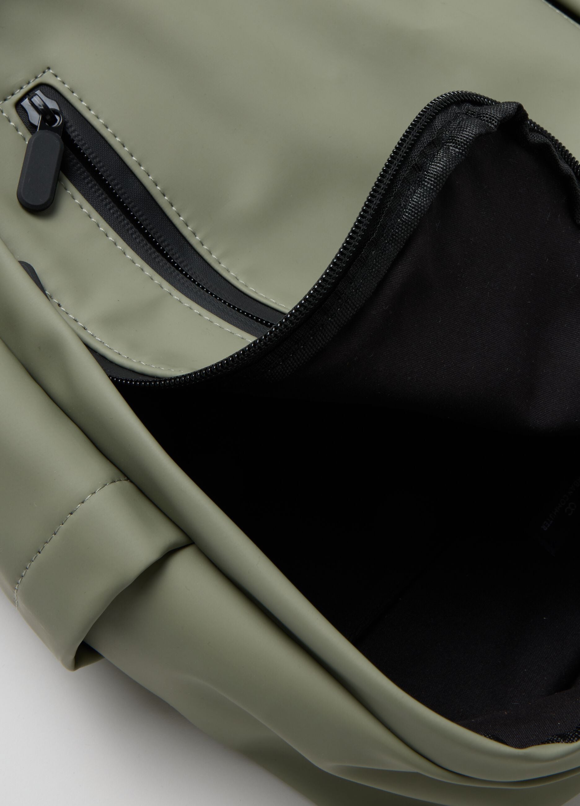 Green backpack with adjustable straps and multiple pockets