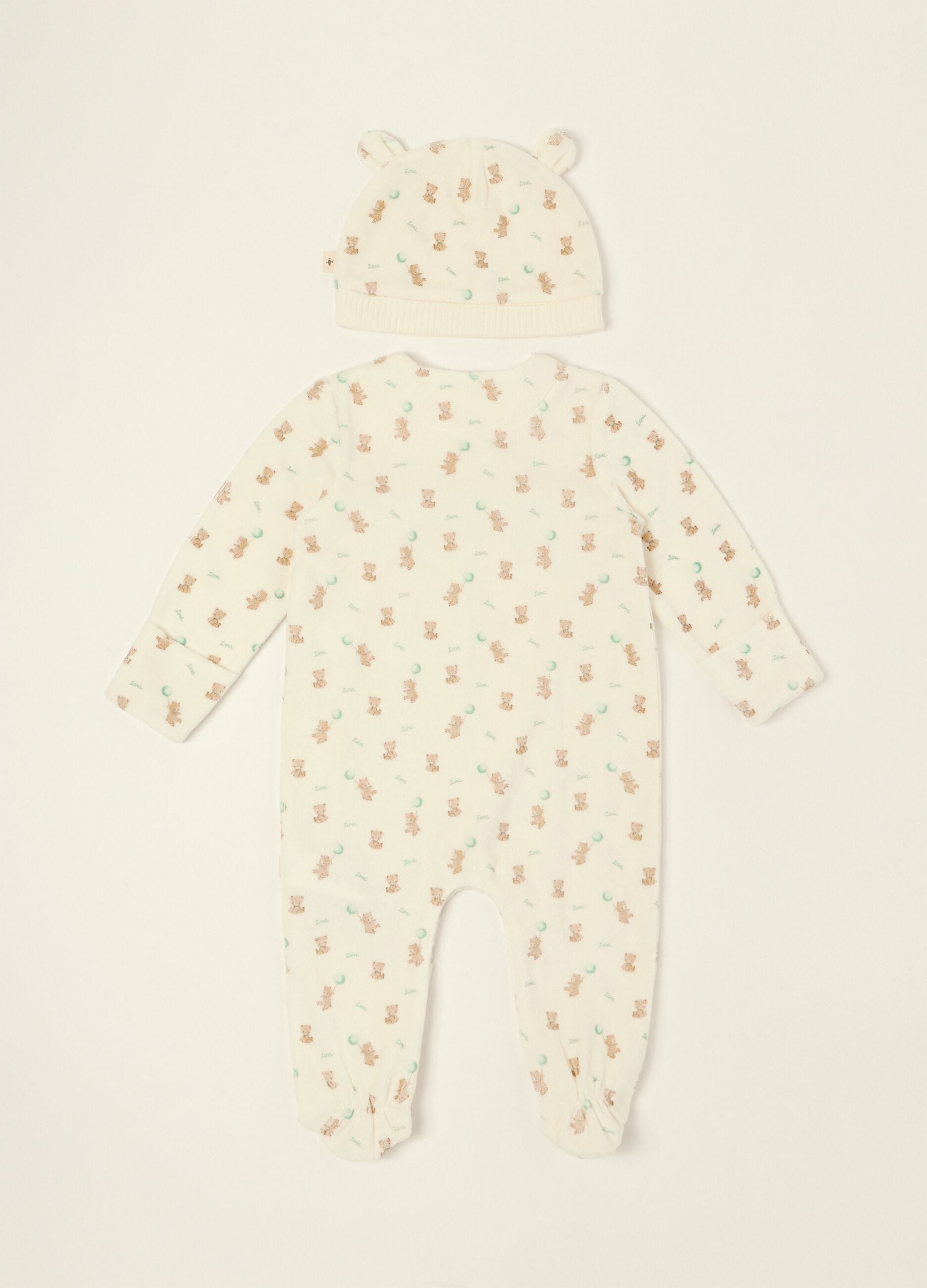White baby sleepsuit with teddy bear print